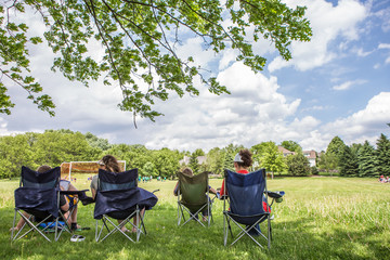 Parents sitting watching a childrens soccer game