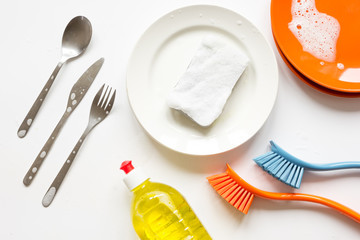 concept of washing dishes on white background top view