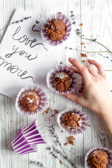 concept of Valentine's Day cupcakes wooden background top view