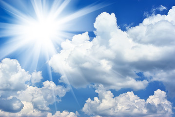 Deep blue sky on sunny day with clouds and big sun