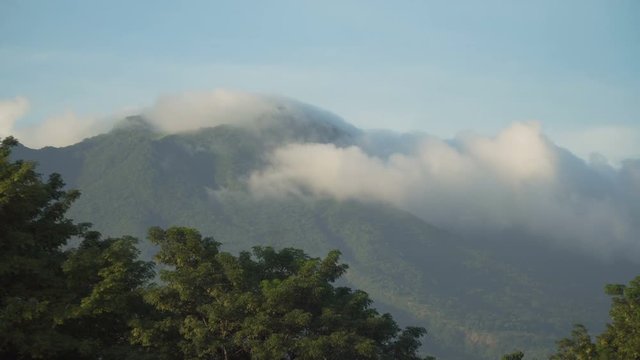 Mountains landscape, rainforest, jungle, blue sky, clouds and mist. Volcano on the island of Camiguin. Travel concept. 4K video