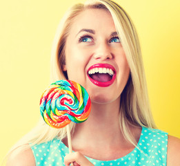 Young woman holding a lollipop