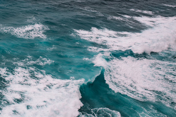 Fototapeta na wymiar Close up of azure waves and white foam of the Indian ocean, Indonesia, Bali