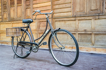 Fototapeta na wymiar Vintage bcycle standing near wood wall