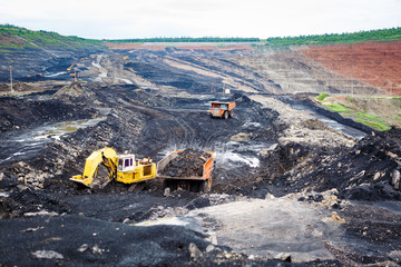 Mining dump trucks working in Lignite coalmine