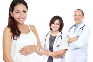 pregnant asian woman standing in front of her doctor