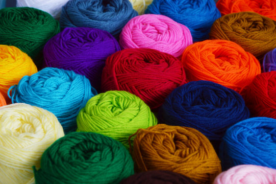 Blurry background of colorful knitting. View from above of colorful knitting.