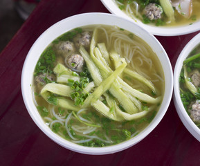 Bowl of noodles made from vermicelli, with green onion, bean sprouts and chili