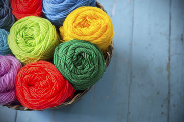 Blurry background colorful knitting in wooden basket