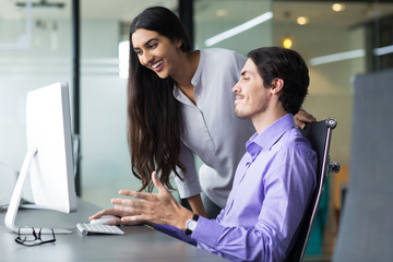 Two Business People Using Computer in Office