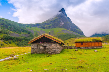 Typical house with grass on the roof in a mountain village. Norway