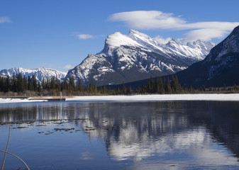 Fototapeta na wymiar Mount Rundle reflected in the icy waters of Vermillion Lakes near Banff Alberta Canada