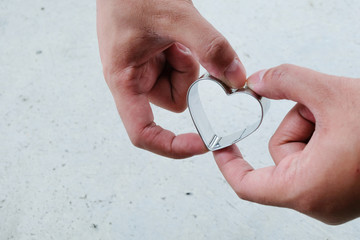 Heart shaped cookie cutter in hands