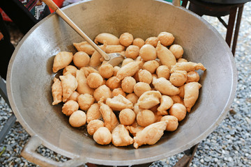 meatballs frying in hot oil
