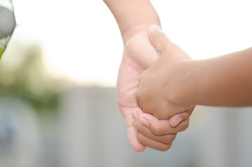 .Two little kids holding hands and holding hands walking. The me