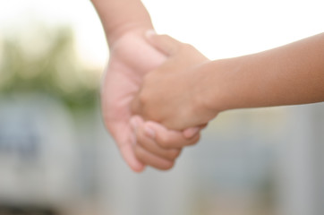 .Two little kids holding hands and holding hands walking. The me