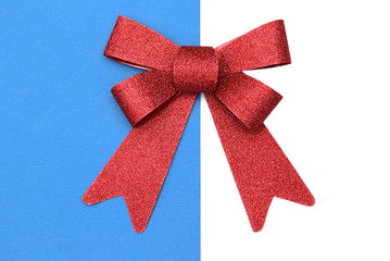 Red bow for presents on white blue background