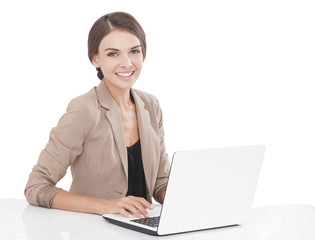 businesswoman smiling while working on her laptop