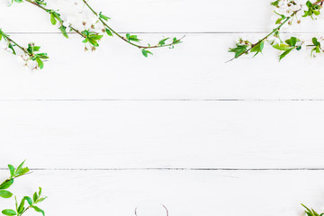 Spring flowers. Apple flowers on white wooden background. Flat lay, top view