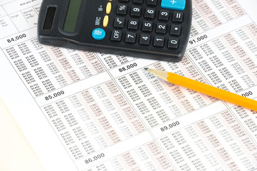 tax calculation form with calculator and pencil on the form