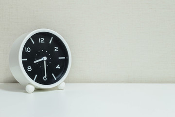 Closeup black and white alarm clock for decorate show show half past eight or 8:30 a.m. on white...