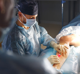 doctor and an assistant in operating room for surgical  clinic