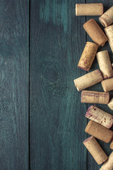 Wine corks on dark wooden texture with copyspace