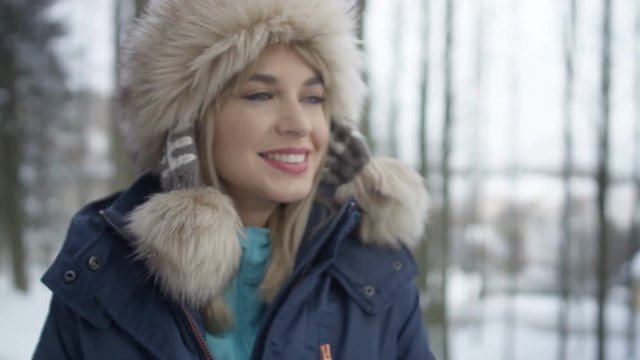 Portrait of smiling woman enjoying winter in a forest. Shot on Red Epic.