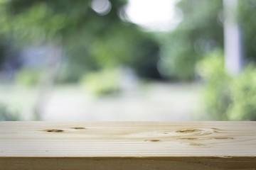 Wood table top on blur of nature background, used for display your products