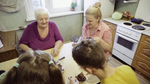 Family at the kitchen table 

Celebrating a small family holiday in the circle of their loved ones.