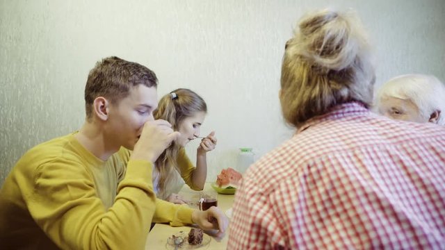 Family at the kitchen table 

Celebrating a small family holiday in the circle of their loved ones.