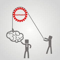 he concept of teamwork - a man holds up a brain on a rope