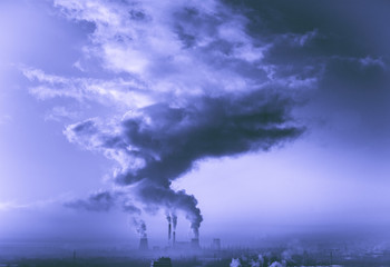 View in thermal power plants. Through the large clouds punched sunlight.

