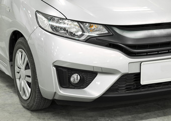Obraz na płótnie Canvas Car headlight of silver automobile closeup