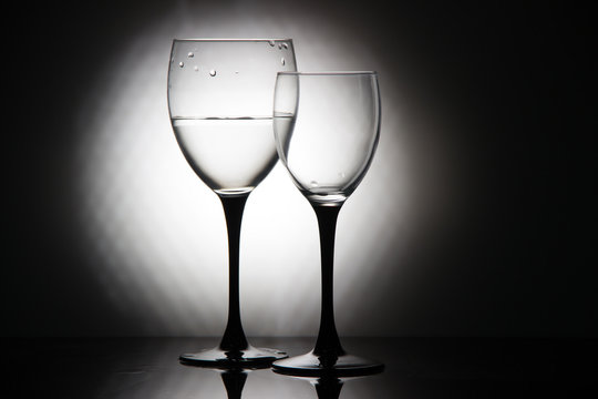 Glasses of champagne and a bottle of wine on a black background
