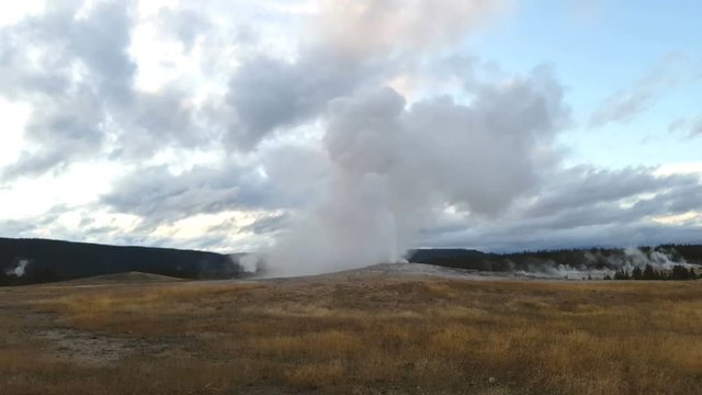 Old faithful geyser erupting, at yellowstone national park, in Wyoming, United states of America