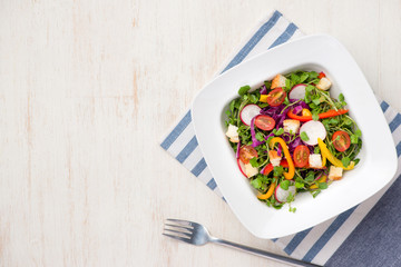 Homemade fresh green vegetable salad on table.