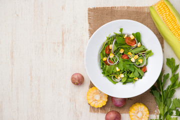 Homemade fresh green vegetable salad on table.