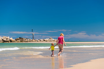 Grandmother with grandson on the beach