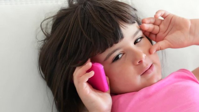 little girl who talks to a telephone toy