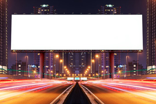 Double exposure of white blank billboard on blur light trails, street, city and urban in the night - can advertisement for display or montage product or business.