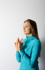 Young woman performing an exercise of yoga breathing