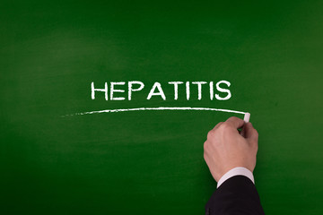 HEPATITIS word written by hand on blackboard
