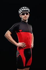 Sport. Cyclist in training clothes on black background.