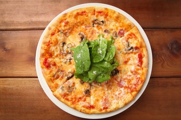 arugula  pizza on table