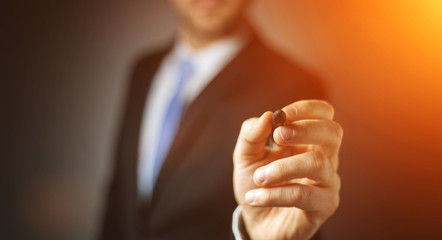 Businessman writing with a pen on a digital screen