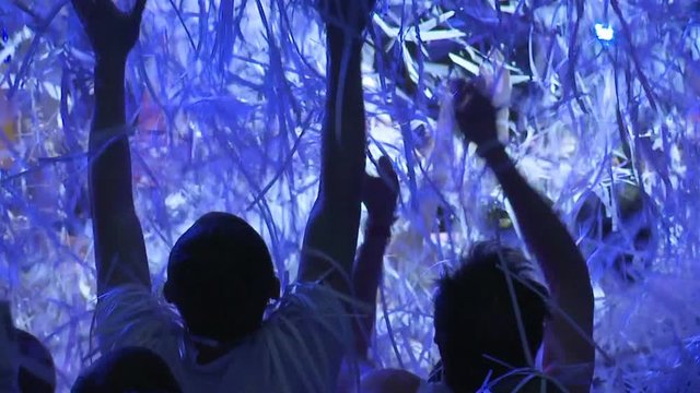 Footage of a crowd partying, dancing slow motion on the paper party.Young people at the party.