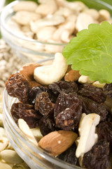 raisins, nuts mix, raisins, sunflower seeds in bowls 