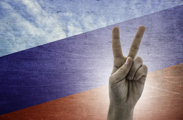 Victory symbol - two fingers against background of Russia flag