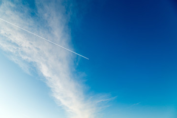Trace from the plane in a blue sunny sky